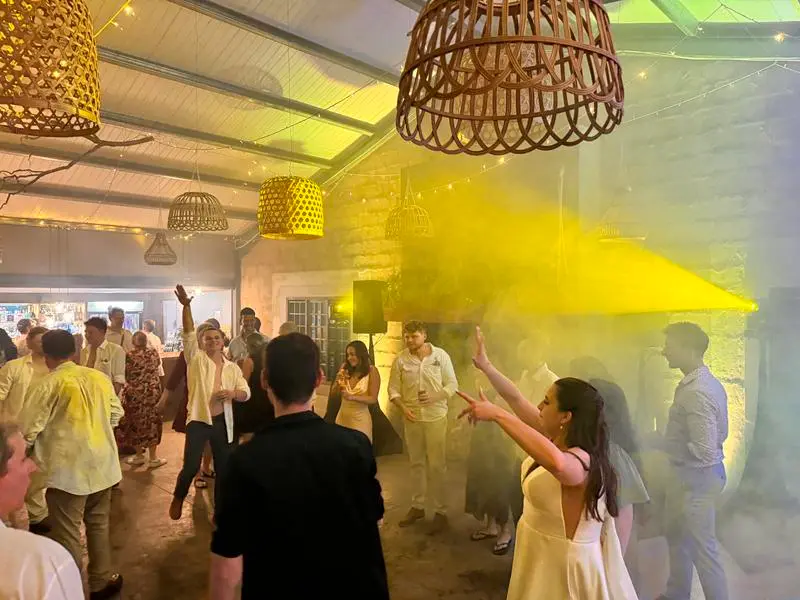 A yellow beam cutting through haze over the dancefloor at Haycroft Farm
