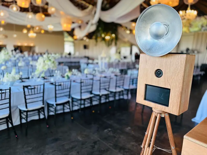 A wooden photobooth beside the reception tables at Brahman Hills