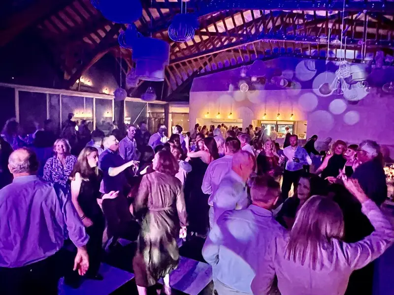Guests dancing under purple lighting at a Brahman Hills wedding reception