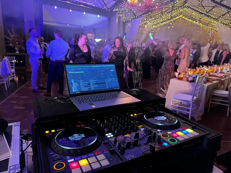 Jarryd Sunkel's DJ decks with the Netherwood Farm crowd dancing beyond them