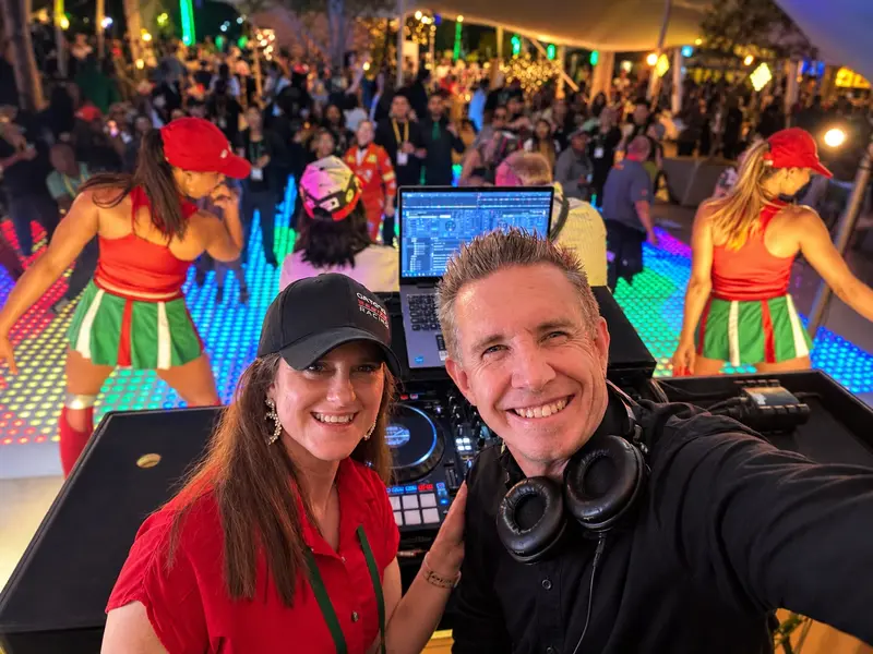 Jarryd Sunkel taking a selfie at the decks with the race-day hosts dancing behind him