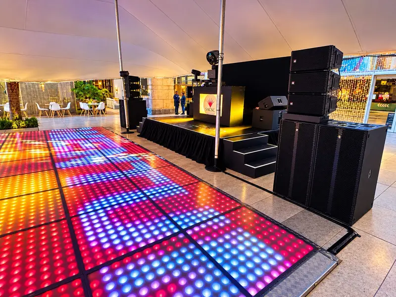 LED dancefloor, stage and RCF speakers set up under a stretch tent at Gateway before guests arrived
