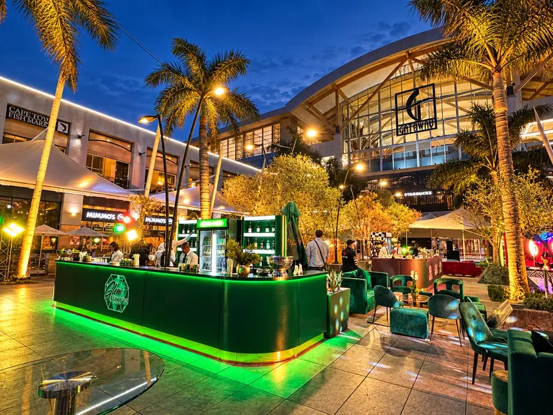Gateway Theatre of Shopping at dusk, with a green-lit bar set up for the SACSC After Party