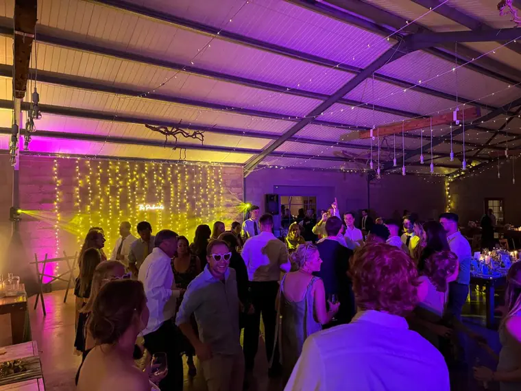 Full marquee dancefloor in front of a fairy-light curtain