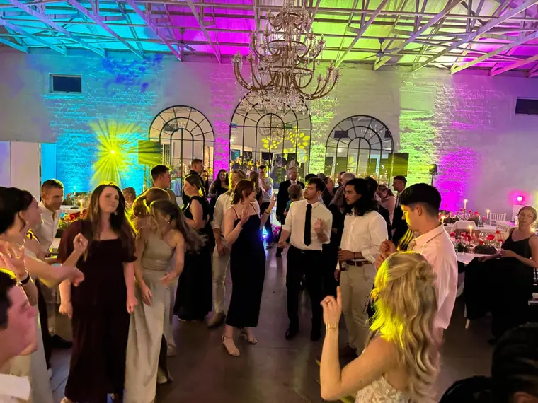 Guests dancing under colour uplighting at a KZN Midlands wedding