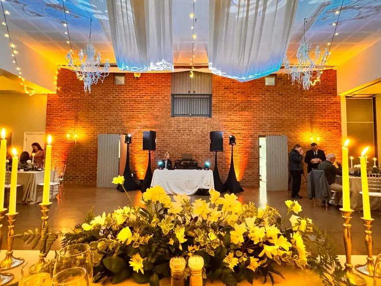 Candlelit top table against the stone wall at Fordoun