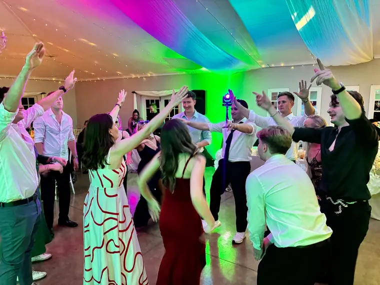 Guests dancing under green and purple lighting at Providence Country Estate