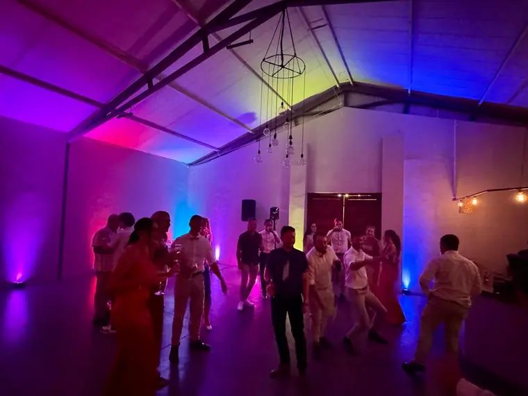 Purple and blue uplighting across the reception hall at Sweet Home
