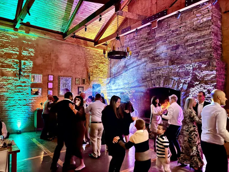 Guests dancing against the stone wall at The Gallery