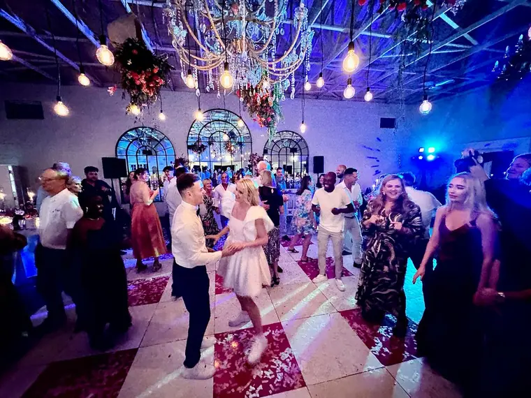 Guests dancing under festoon lights at The Groves