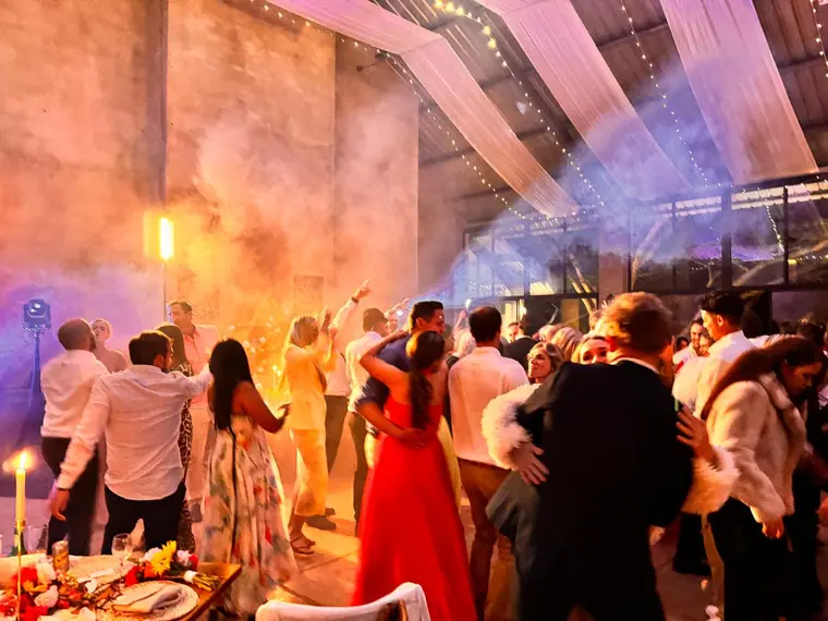 Haze and warm lighting across the barn dancefloor at Wingrove Valley